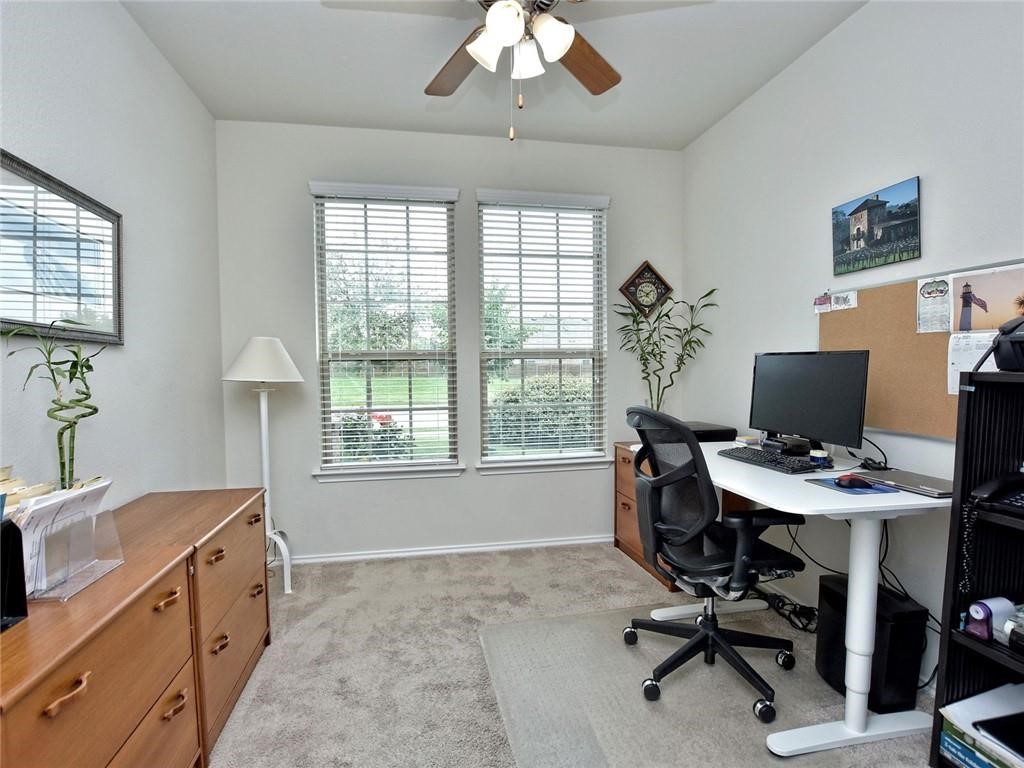 305 Methodius Drive Hutto, TX 78634 - Photo 20 of 26 a view of a workspace with furniture and a window