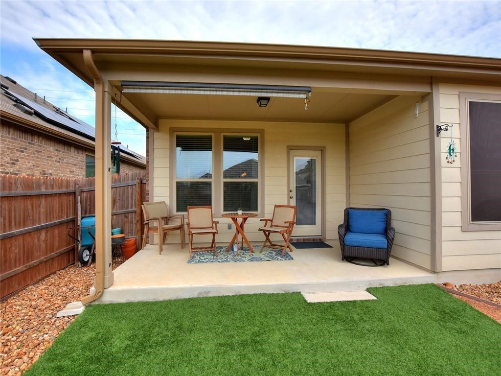 305 Methodius Drive Hutto, TX 78634 - Photo 22 of 26 a view of a patio with table and chairs with wooden floor and fence