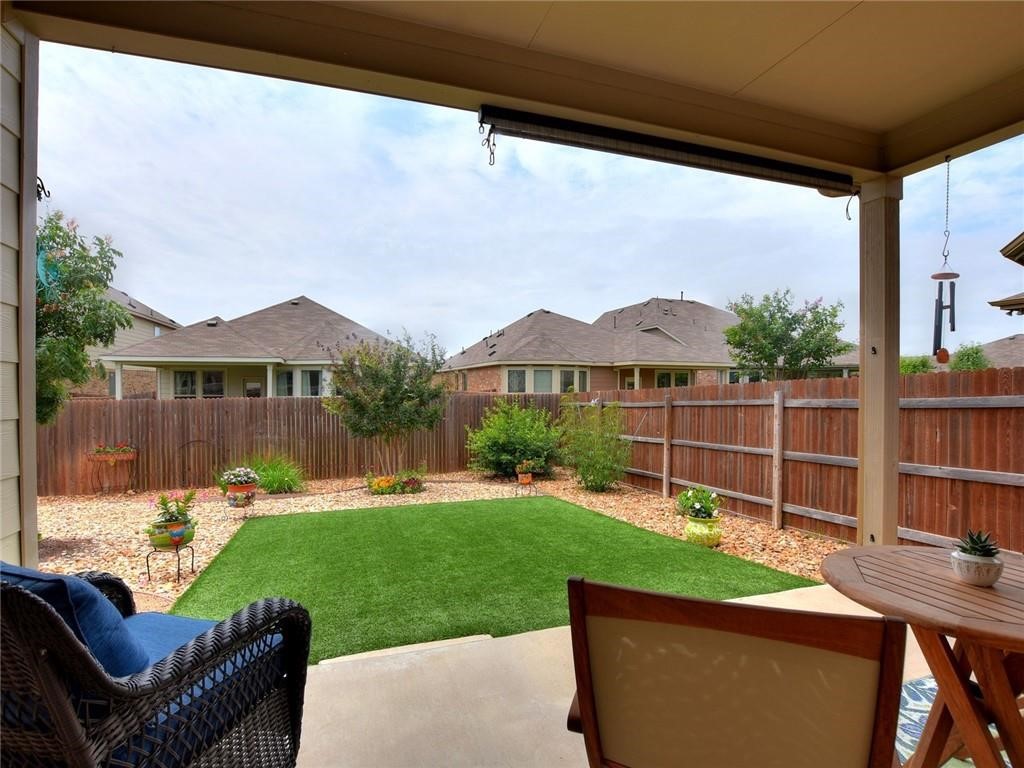 305 Methodius Drive Hutto, TX 78634 - Photo 24 of 26 a view of a patio with table and chairs and potted plants