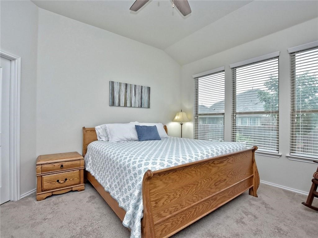 305 Methodius Drive Hutto, TX 78634 - Photo 4 of 26 a bed sitting in a bedroom next to a window