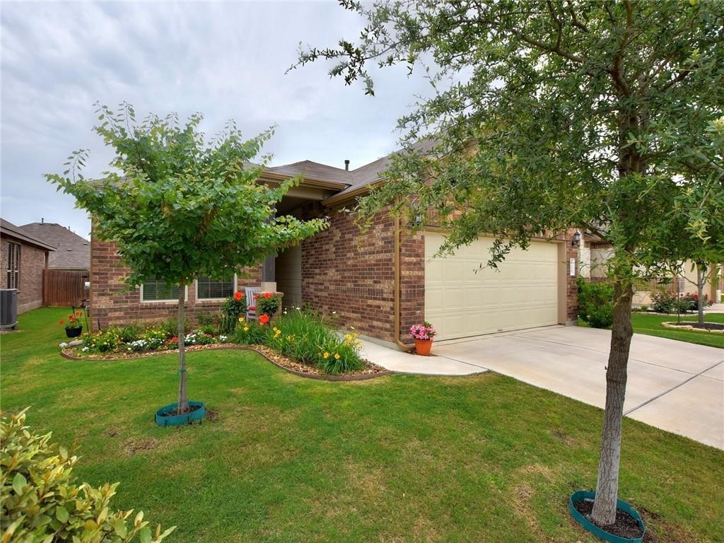 305 Methodius Drive Hutto, TX 78634 - Photo 6 of 26 a view of a chair and table in backyard