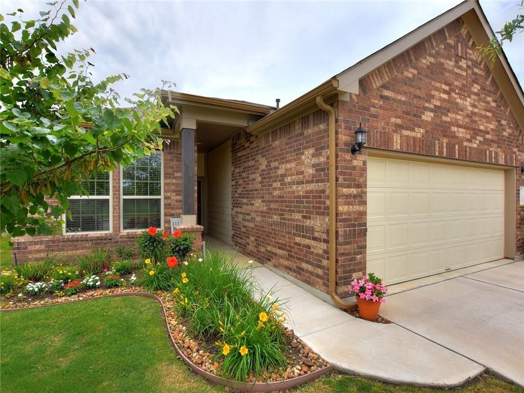 305 Methodius Drive Hutto, TX 78634 - Photo 7 of 26 a front view of a house with a garden