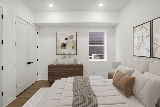 a bedroom with a bed and a painting on the wall