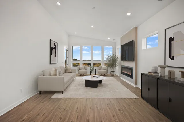 a living room with fireplace furniture and a flat screen tv