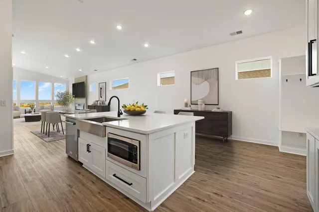 a kitchen with stainless steel appliances a white stove top oven sink and cabinets