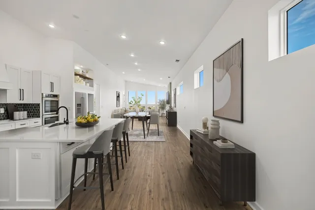 a living room with furniture a wooden floor and a sink