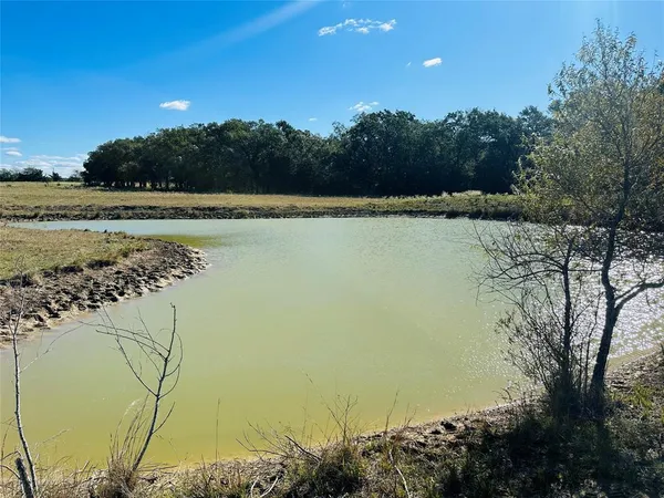 a view of a lake with a yard