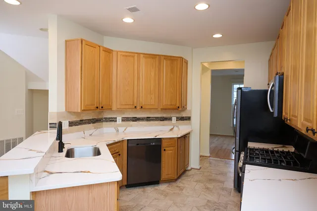 a kitchen with a sink stove and refrigerator