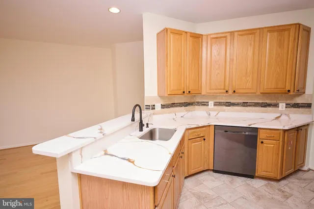 a view of a kitchen with a sink and cabinets