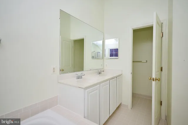 a bathroom with a sink and mirror
