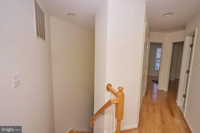 a view of hallway with wooden floor