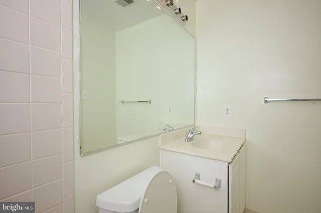 a bathroom with a sink mirror and toilet