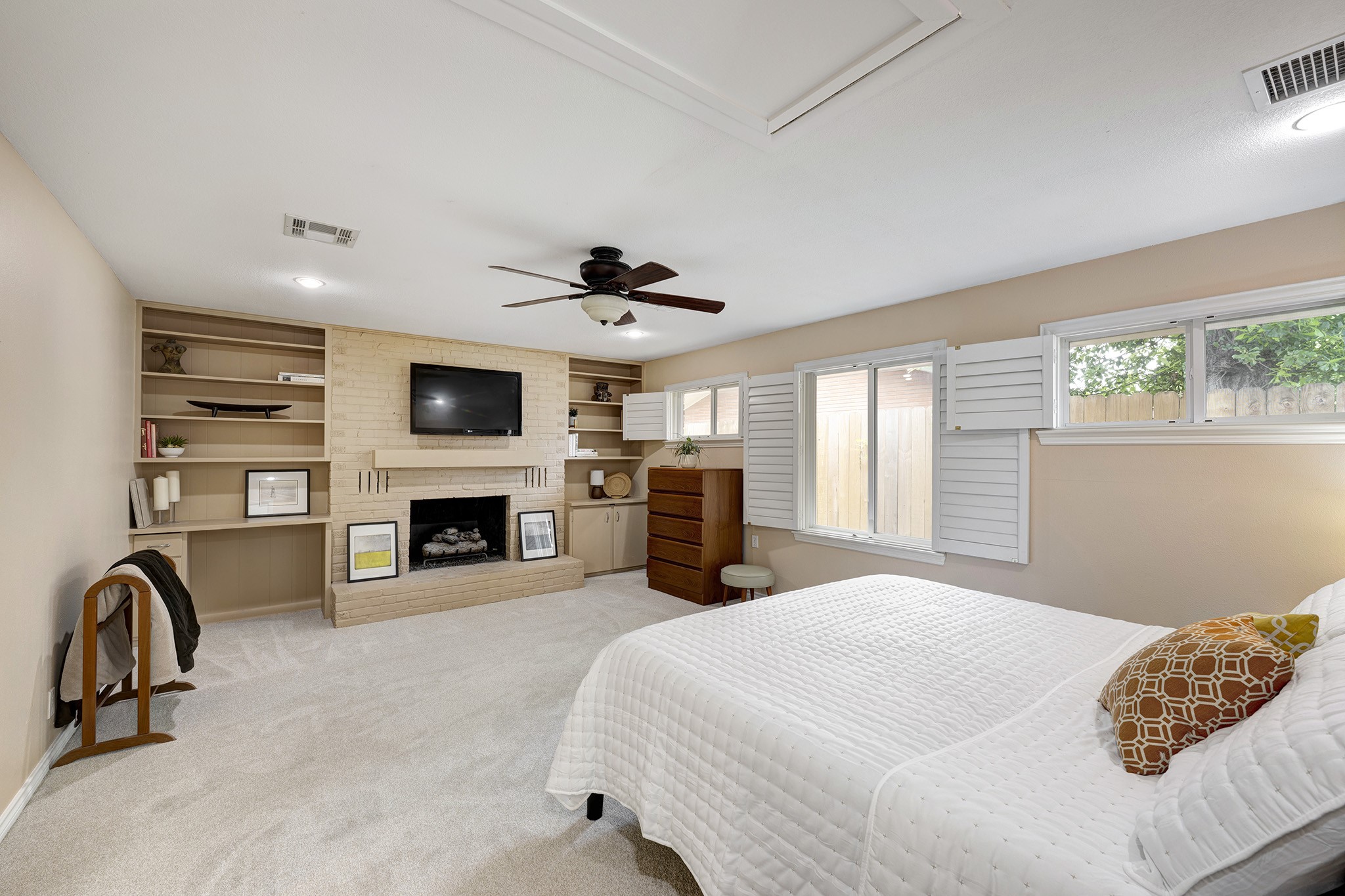 1111 Clovis Road Houston, TX 77008 - Photo 11 of 32 The 19'-5" x 14' Primary bedroom is end capped with a fireplace which is flanked by built-in millwork and a desk.