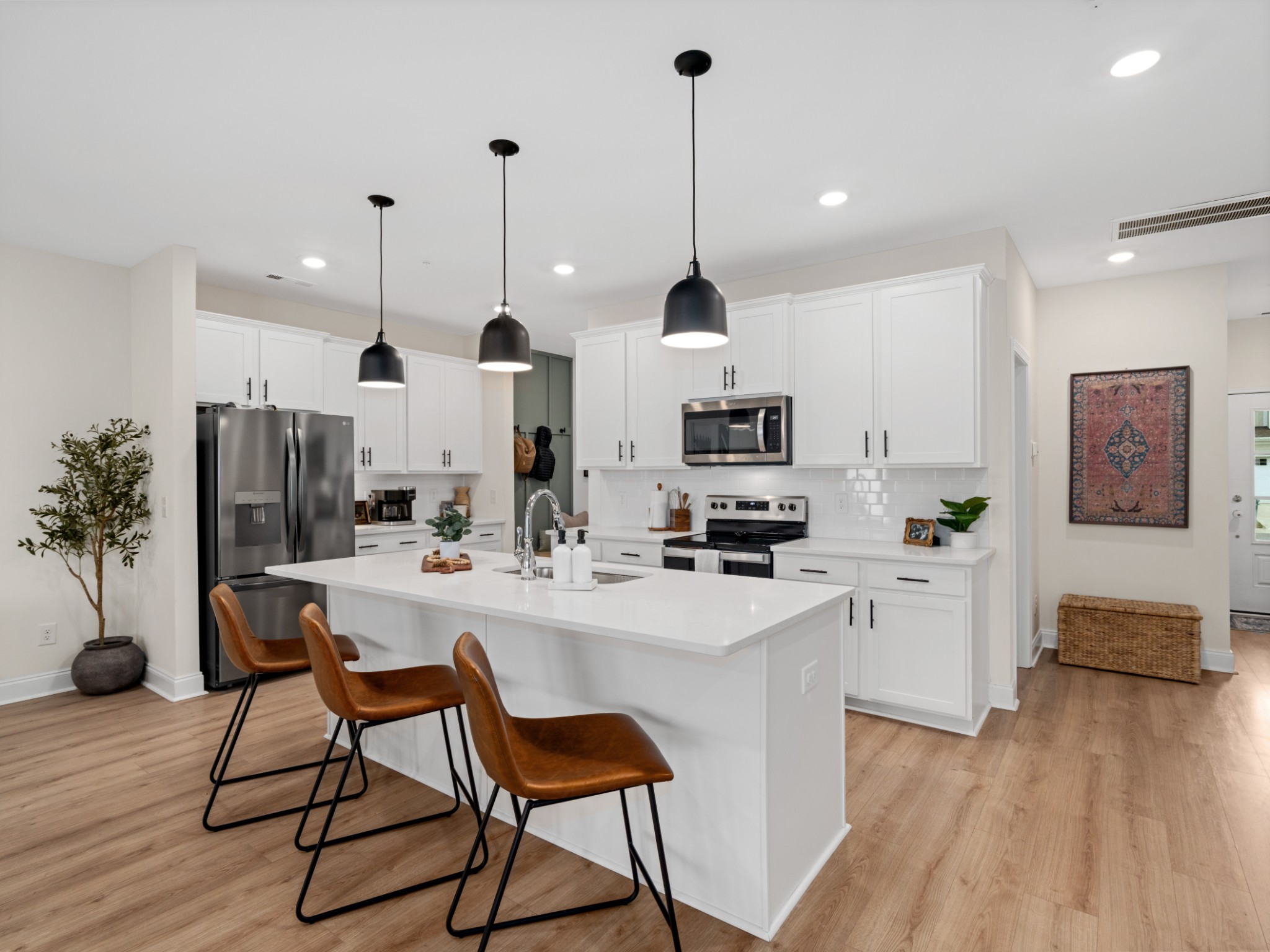 1043 June Wilde Ridge Spring Hill, TN 37174 - Photo 9 of 35 a kitchen with stainless steel appliances kitchen island a refrigerator a stove a sink and a chairs
