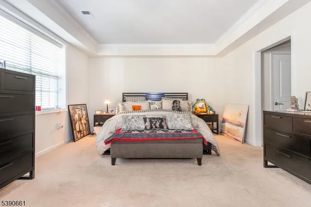 a bedroom with a bed a window and dresser