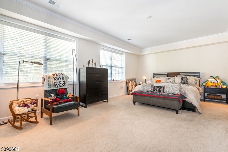 1407 Warren's Way Wanaque, NJ 07465 - Photo 17 of 36 a bedroom with furniture and a flat screen tv