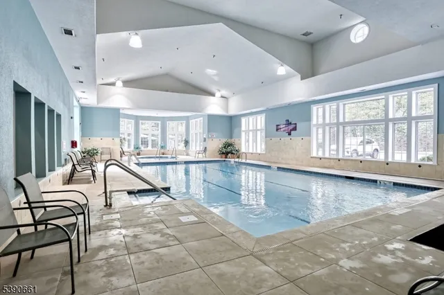 a room with lots of chairs and mirrors