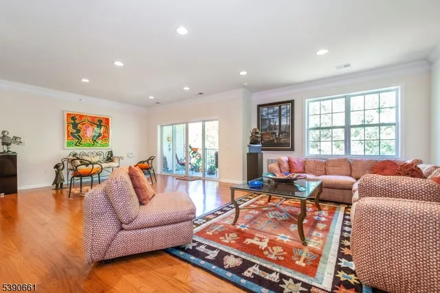 a living room with furniture fireplace and a large window