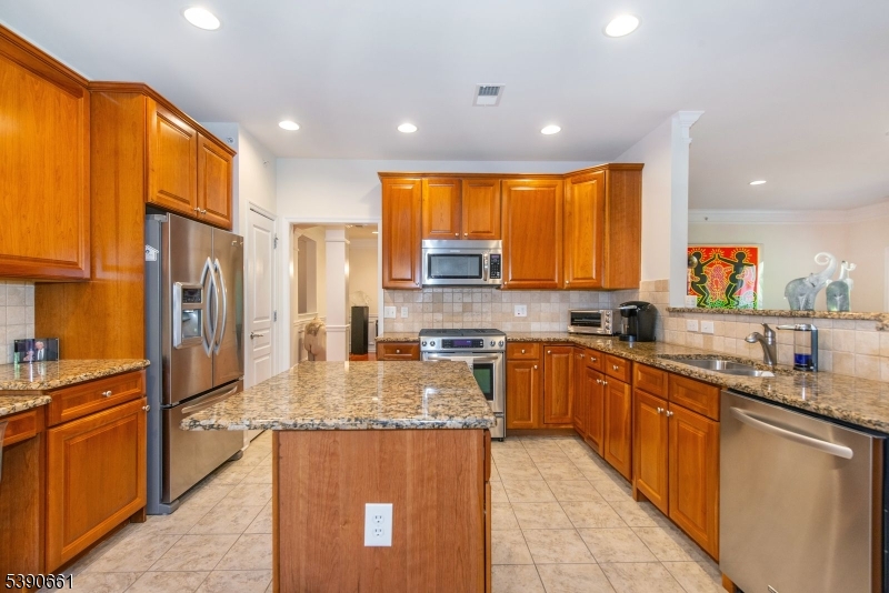 1407 Warren's Way Wanaque, NJ 07465 - Photo 10 of 36 a kitchen with stainless steel appliances granite countertop sink stove refrigerator and cabinets