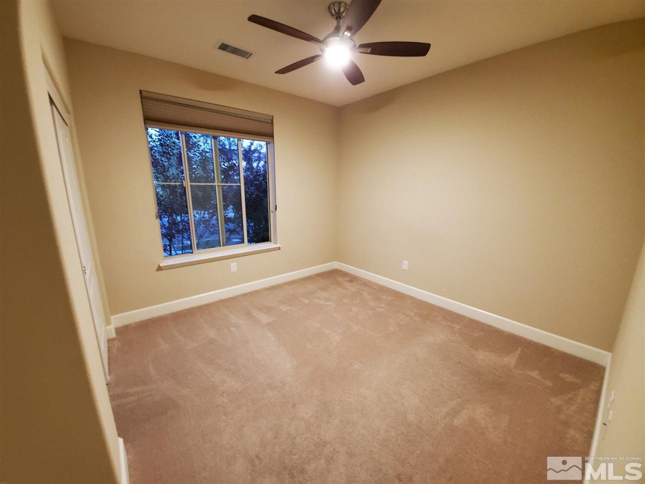 1655 Heavenly View Trail Reno, NV 89523 - Photo 20 of 39 an empty room with windows and fan