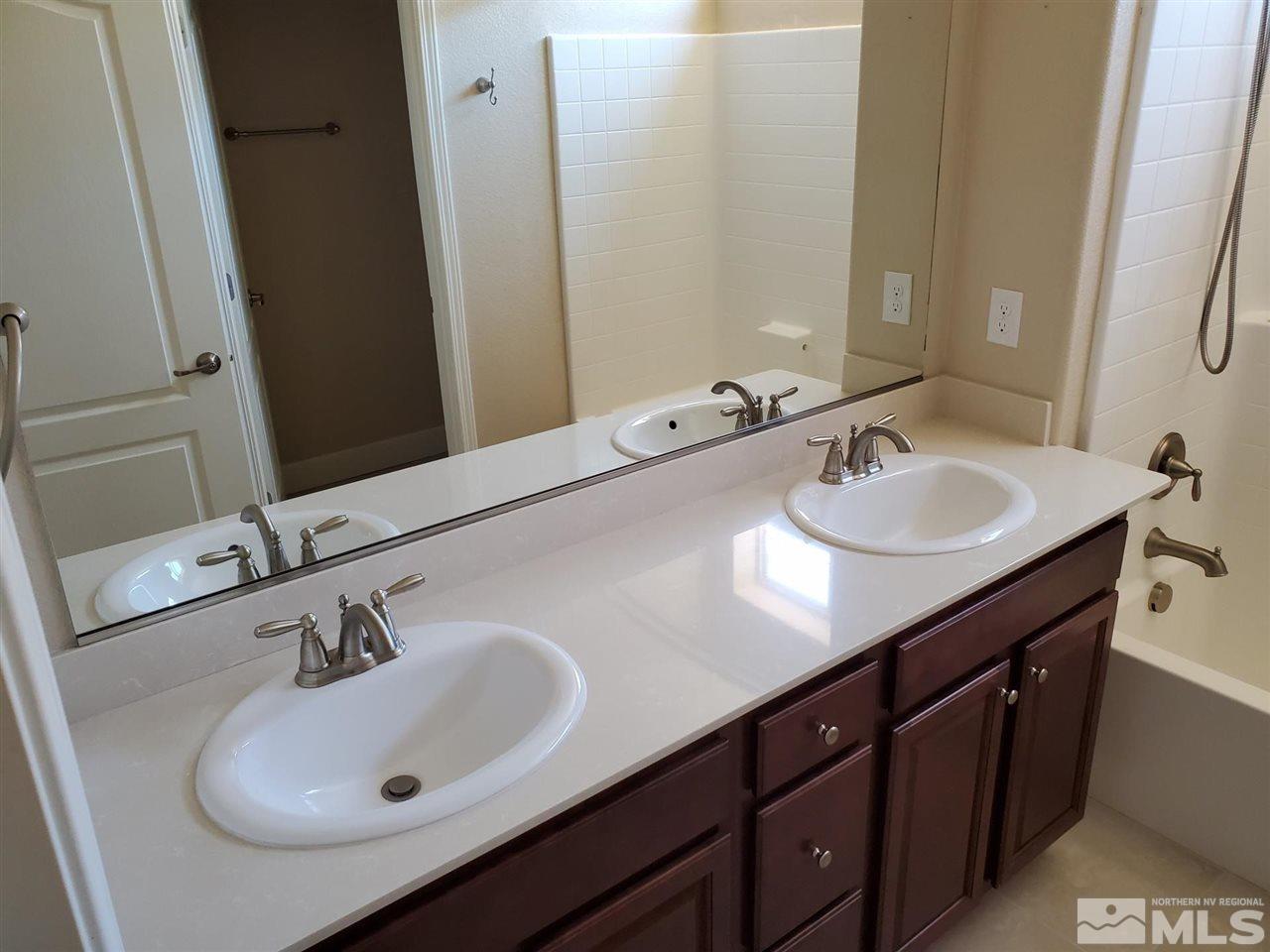1655 Heavenly View Trail Reno, NV 89523 - Photo 23 of 39 a bathroom with a sink and a mirror