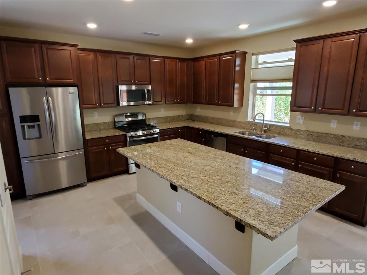 1655 Heavenly View Trail Reno, NV 89523 - Photo 3 of 39 a kitchen with granite countertop stainless steel appliances and wooden cabinets