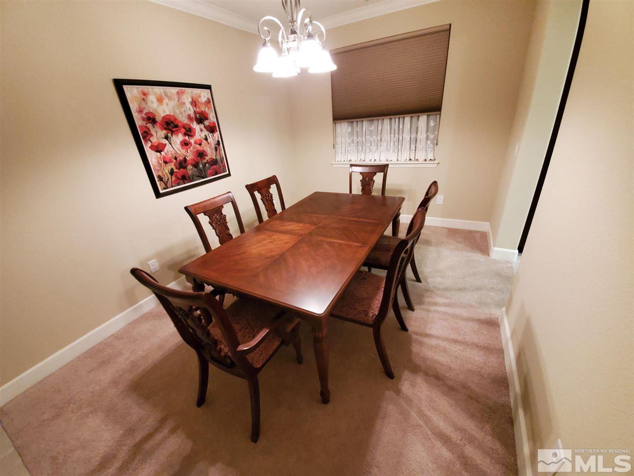 1655 Heavenly View Trail Reno, NV 89523 - Photo 10 of 39 a view of a dining room with furniture a chandelier and wooden floor