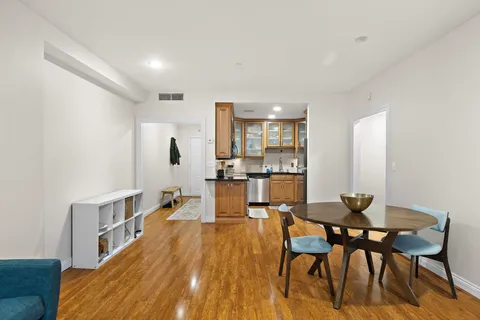 a kitchen with a sink wooden floor and a large window