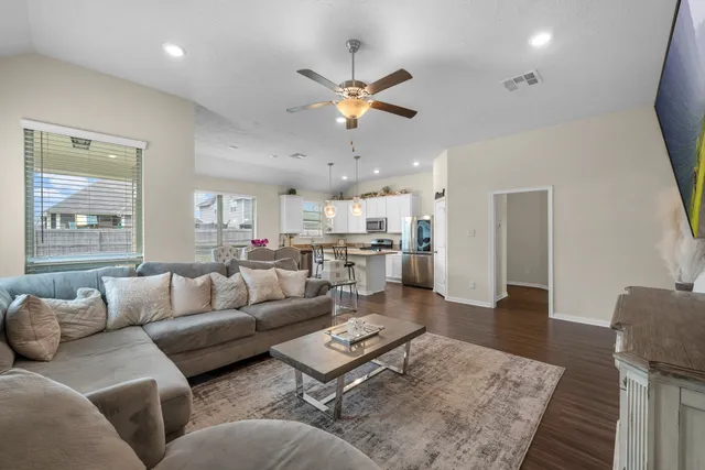 a living room with furniture and kitchen view