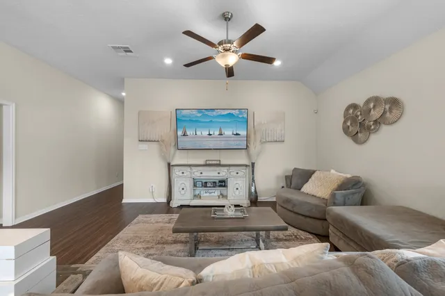 a living room with furniture and wall paintings