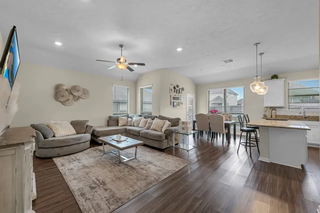 a living room with lots of furniture and a chandelier