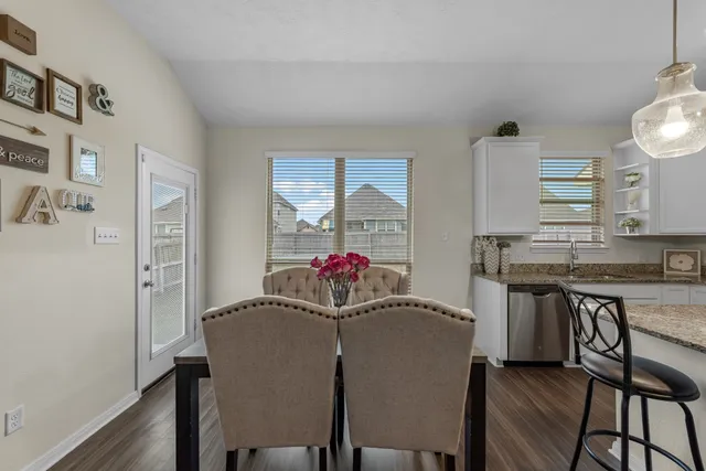 a view of a dining room with furniture and wooden floor