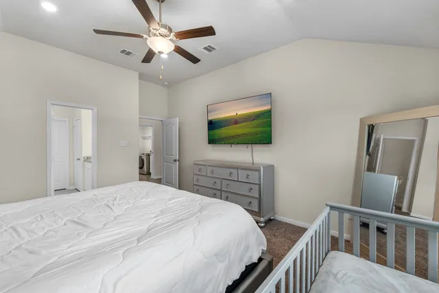 a bedroom with a bed and a flat screen tv