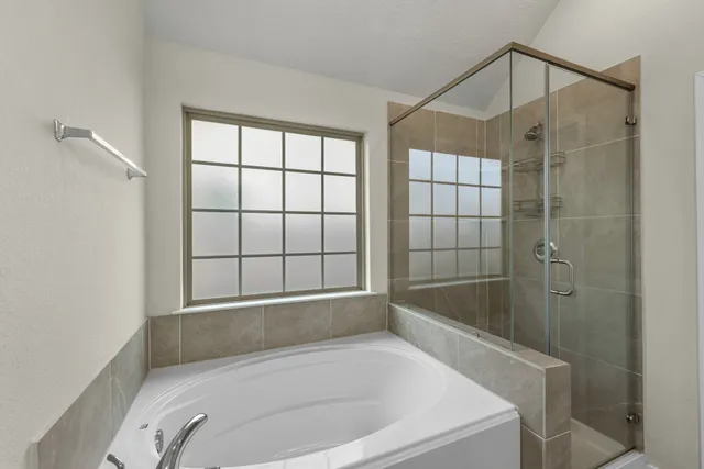 a bathroom with a bathtub and shower