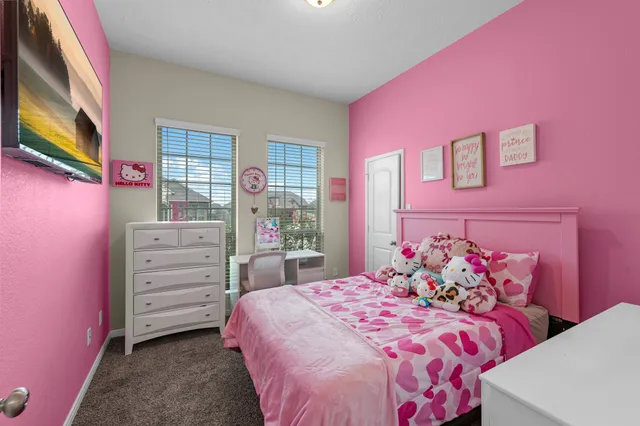 a bedroom with a bed and a dresser