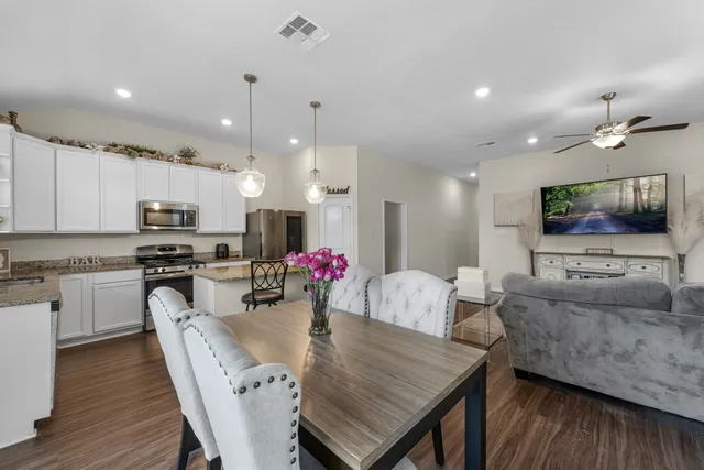 a view of a dining room with furniture and wooden floor