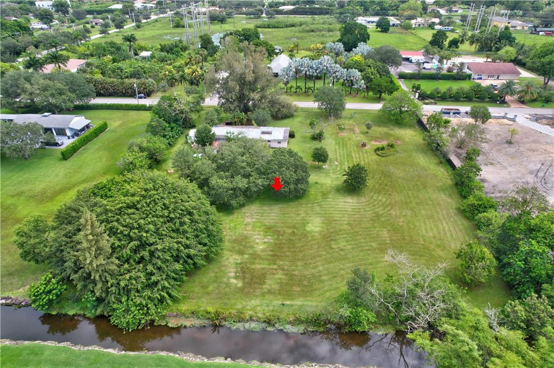 17700 Southwest 68th Court Southwest Ranches, FL 33331 - Photo 5 of 23 a view of a green yard with large trees