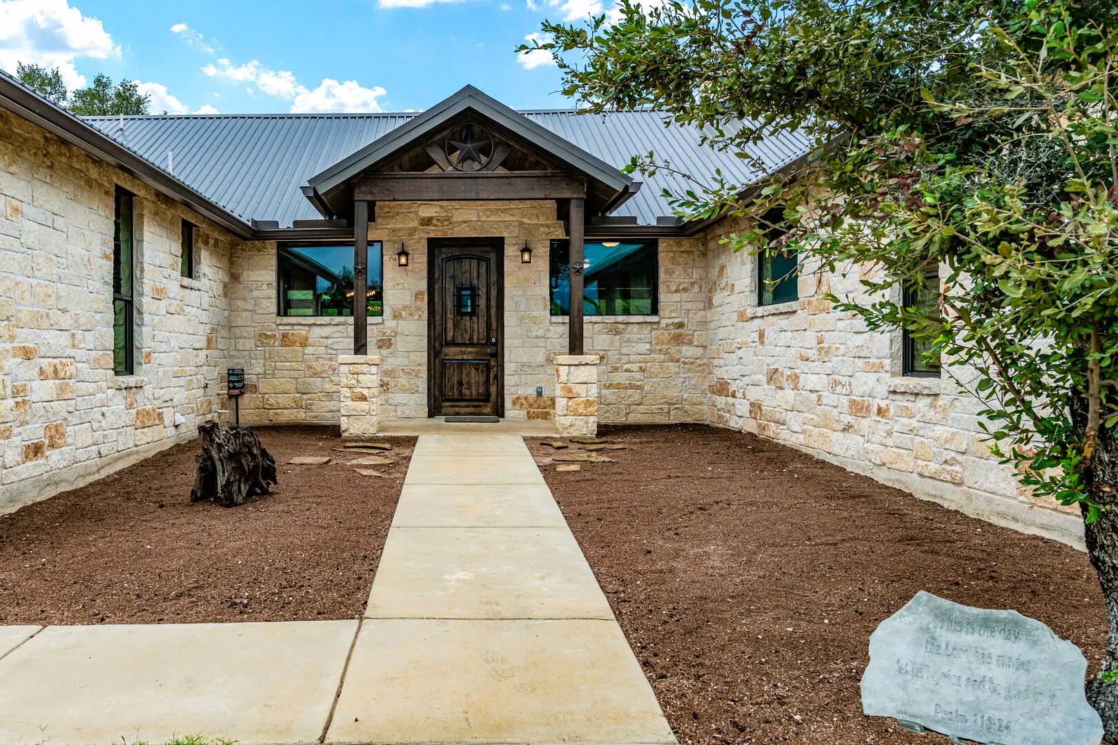 1718 Mountain Valley Road Concan, TX 78838 - Photo 3 of 40 Natural stone masonry and a prominent timber portico define this inviting ranch-style entry.