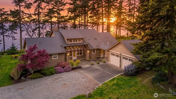 front view of a house with a tree in front of it