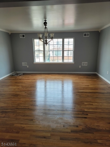 232 Amity Street, Unit 1 Elizabeth, NJ 07202 - Photo 2 of 11 a view of an empty room with wooden floor and a window