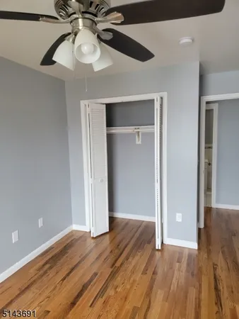 wooden floor in an empty room with a chandelier