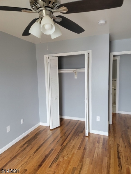 232 Amity Street, Unit 1 Elizabeth, NJ 07202 - Photo 5 of 11 wooden floor in an empty room with a chandelier