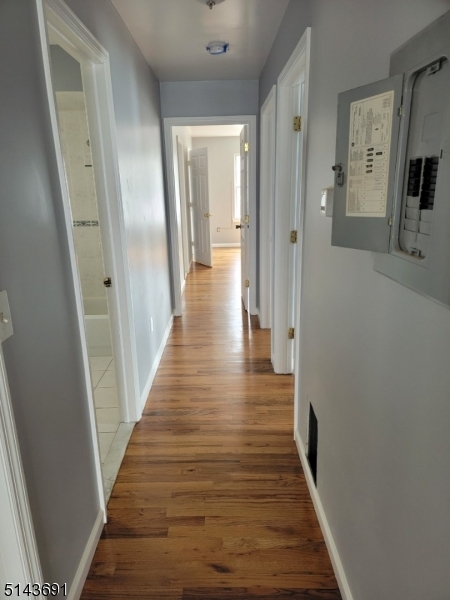 232 Amity Street, Unit 1 Elizabeth, NJ 07202 - Photo 7 of 11 a view of a hallway with wooden floor and staircase