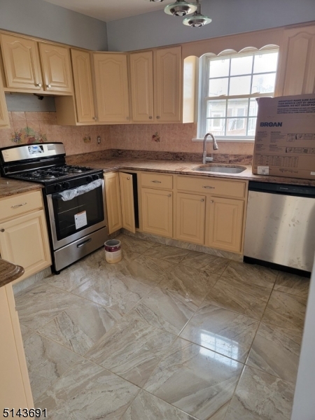 232 Amity Street, Unit 1 Elizabeth, NJ 07202 - Photo 8 of 11 a kitchen with granite countertop a stove a sink and a granite counter tops