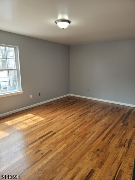 232 Amity Street, Unit 1 Elizabeth, NJ 07202 - Photo 10 of 11 an empty room with wooden floor and windows