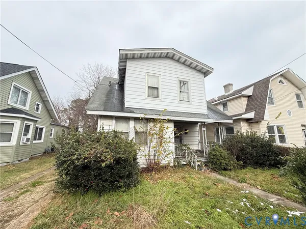 a view of a white house next to a yard