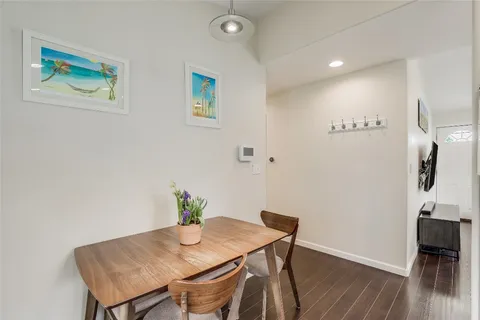a view of a workspace with furniture and wooden floor