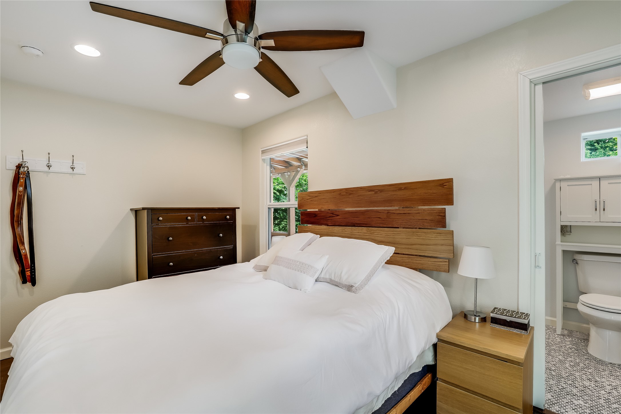 5112 Heflin Lane Austin, TX 78721 - Photo 18 of 38 The primary bedroom is a welcoming retreat with windows overlooking the backyard plus its own ensuite bath.