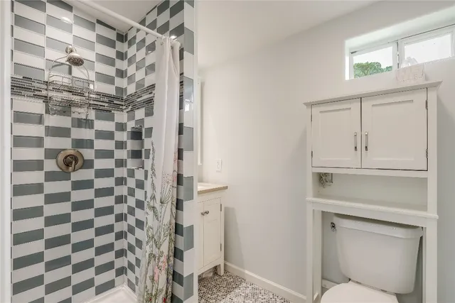 a bathroom with a shower and a sink