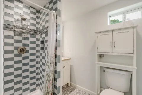 a bathroom with a shower and a sink